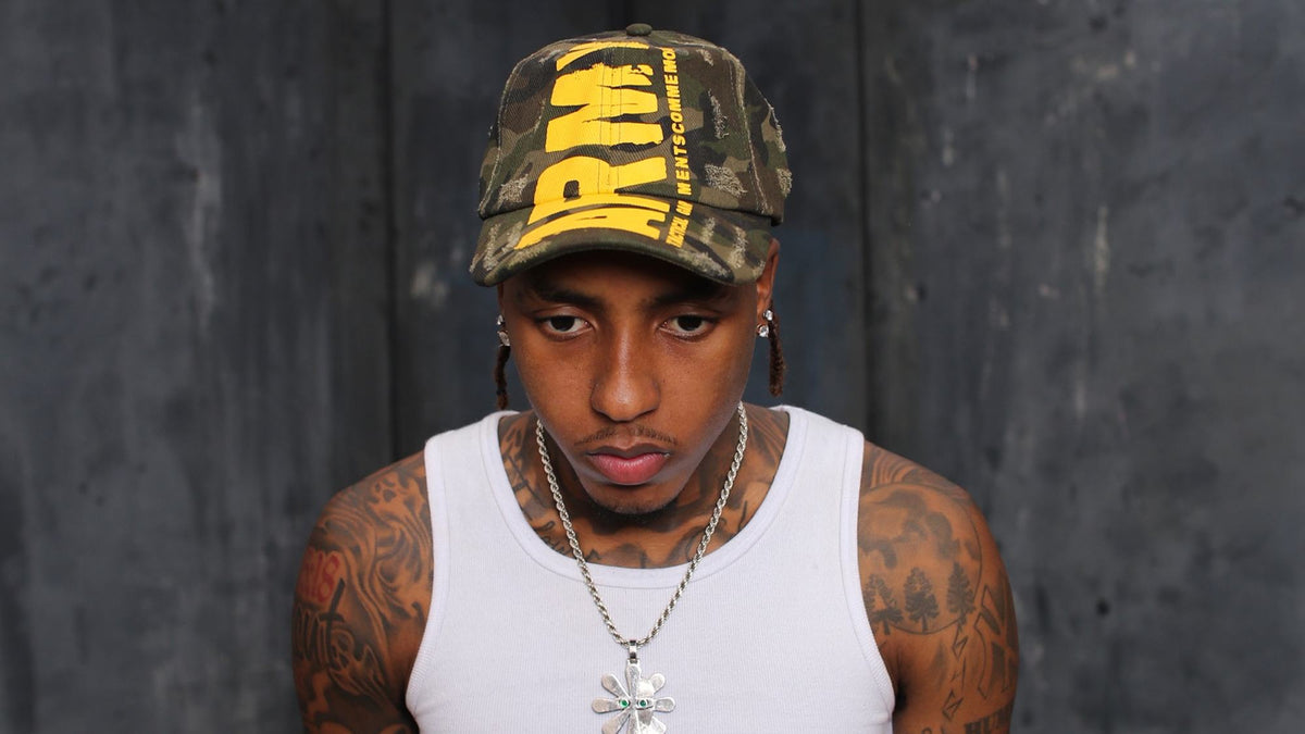 Model wearing the Gouge Worldwide ARMY camo cap